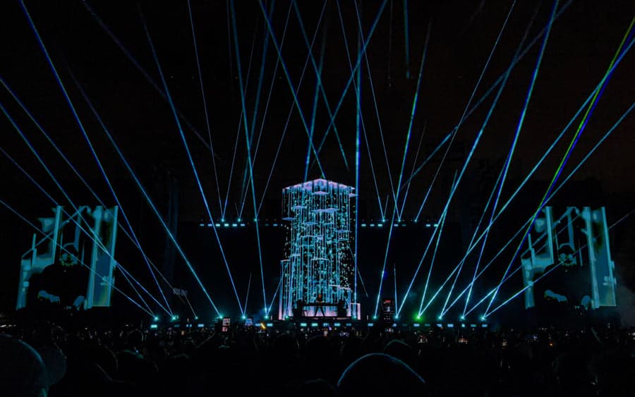Wide laser aerial effects crossing the Monolith Tour stage