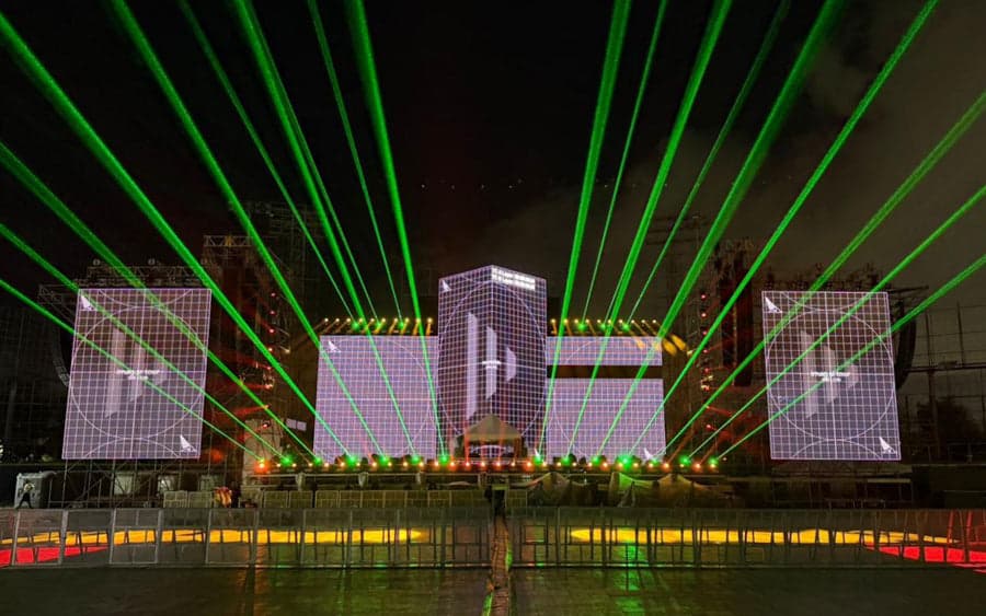 Stadium audience viewing synchronized lasers and video