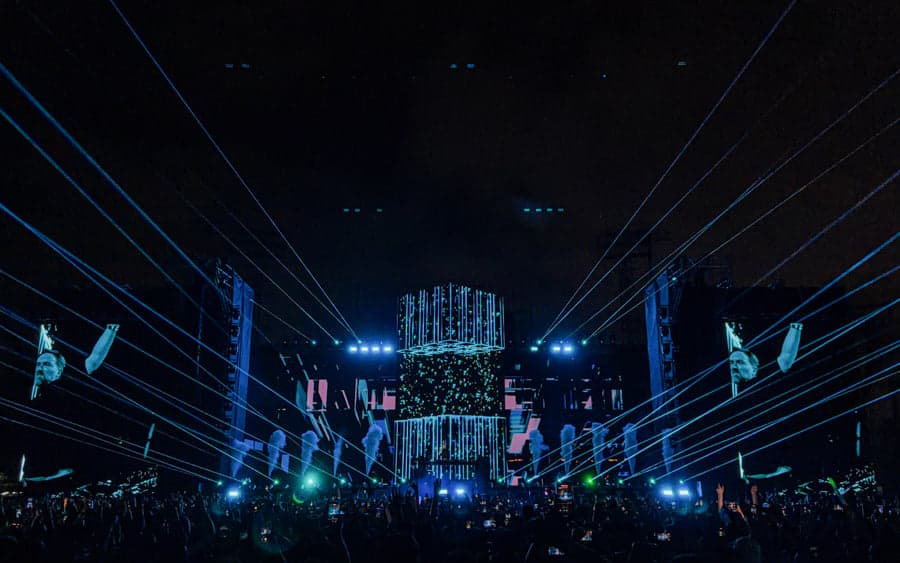 Blue laser lines extend from David Guetta’s Monolith stage across the stadium