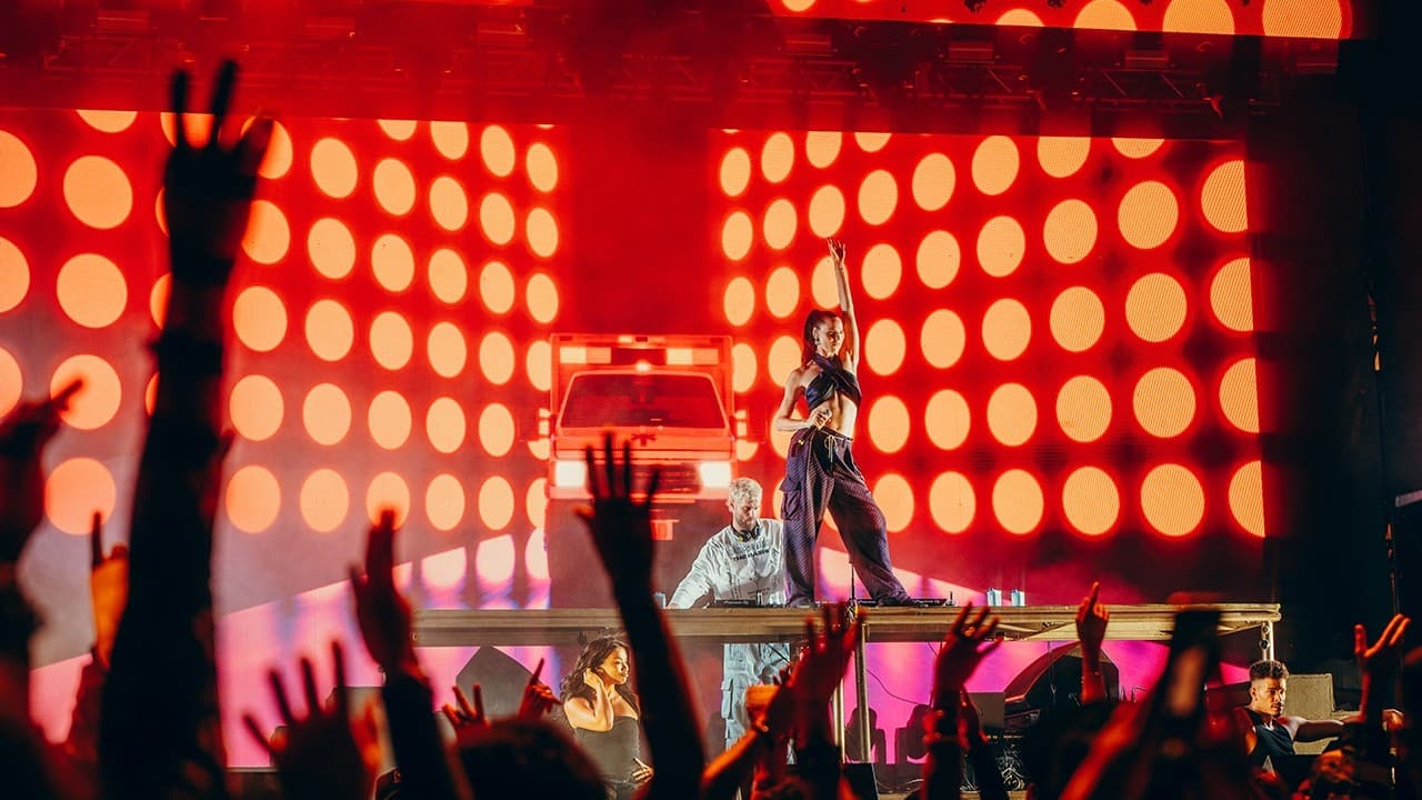 Sofi Tukker performs against red video content at Isle of Light 2026